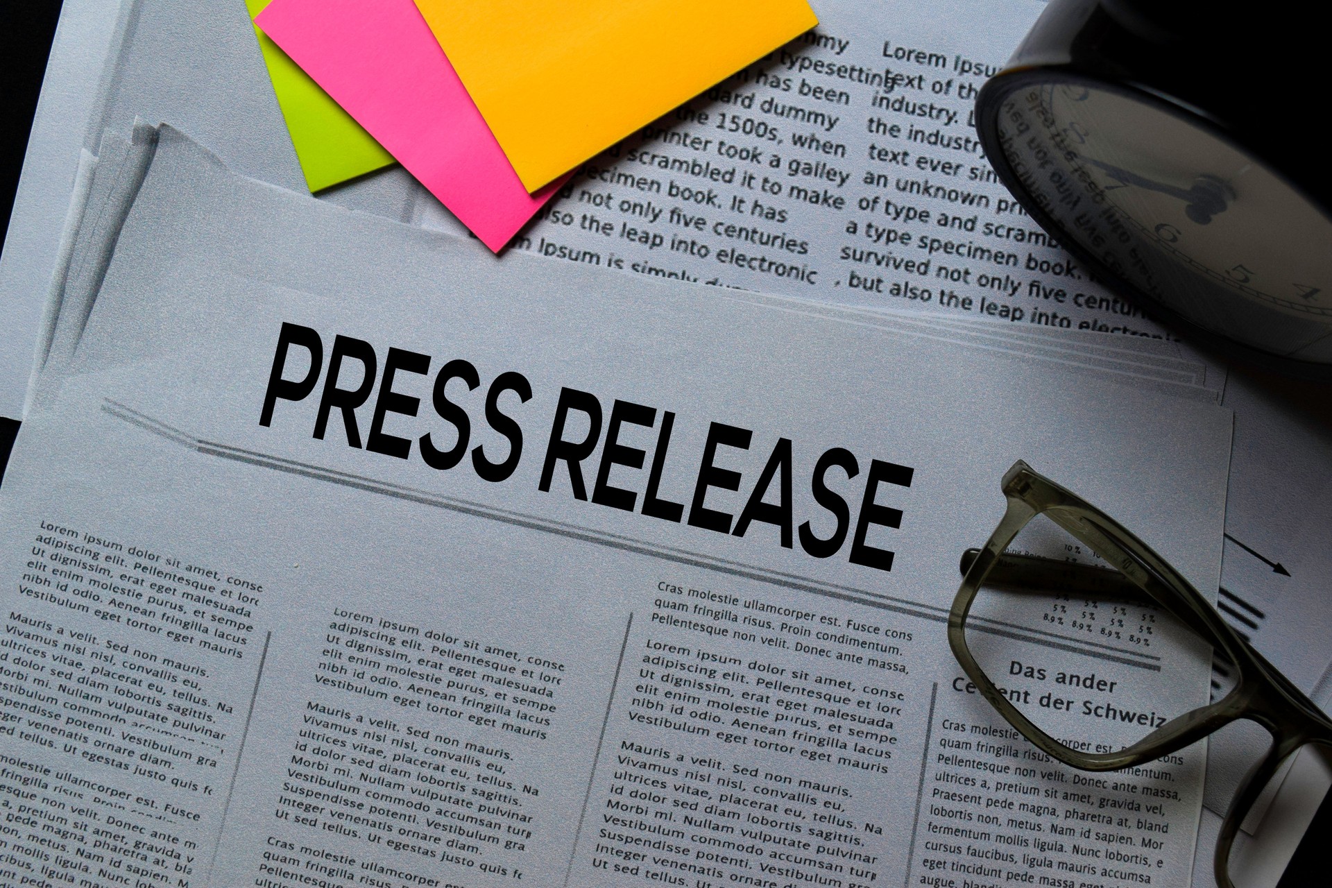 Press Release text in headline isolated on office desk. Newspaper concept